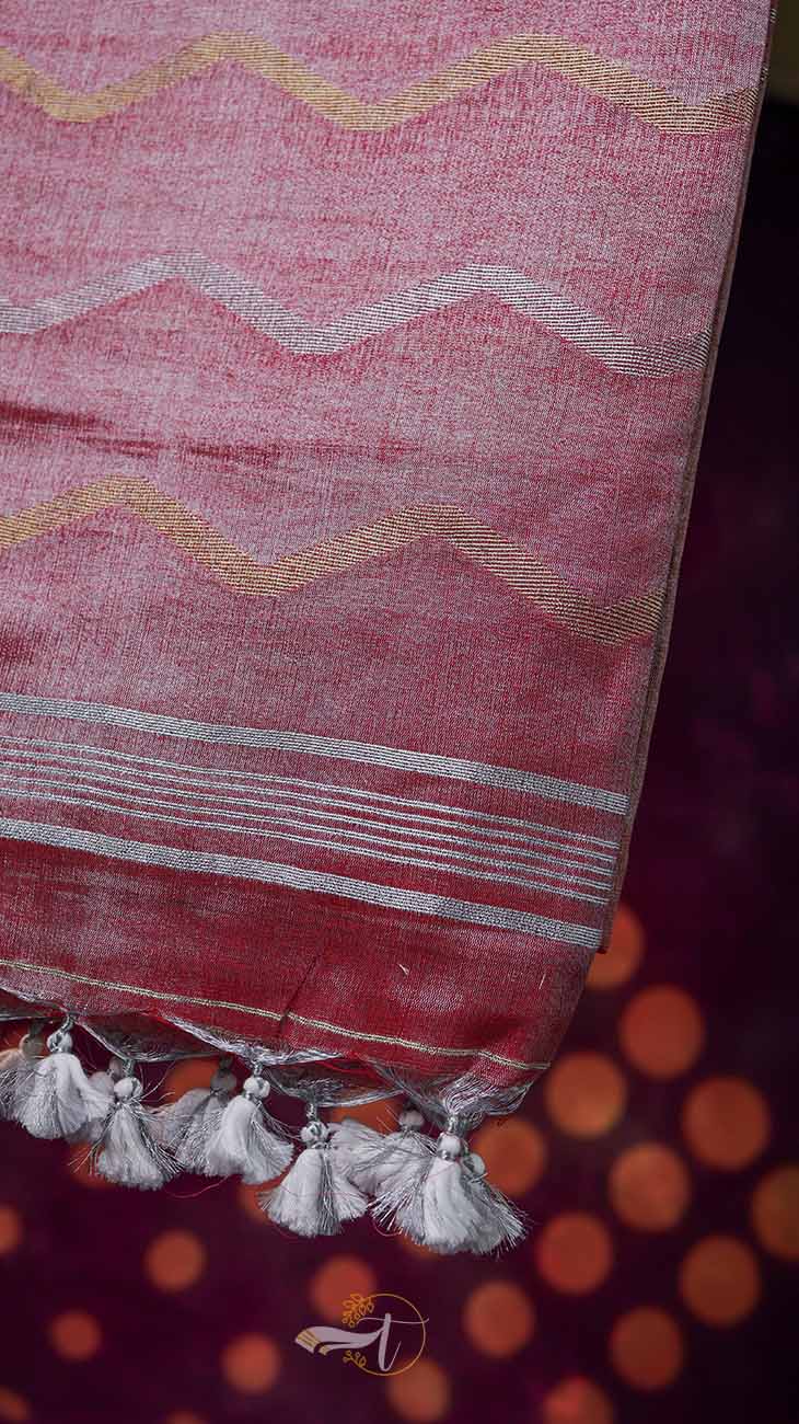 Red fabric with white zigzag pattern and tassels on a dark background