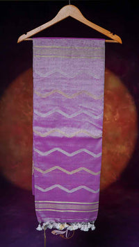 Purple fabric with white zigzag pattern on a wooden hanger against a dark background