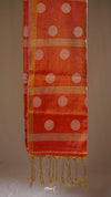 Orange fabric with white polka dots and gold trim on a beige background