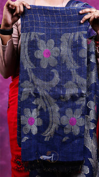 Person holding a blue fabric with floral patterns against a pink background
