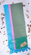 Green scarf with pink and blue stripes on a light background
