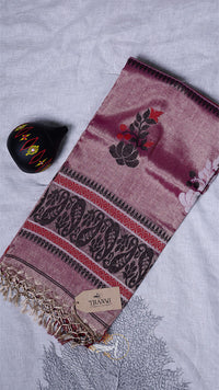 Pink scarf with black floral patterns on a light gray background