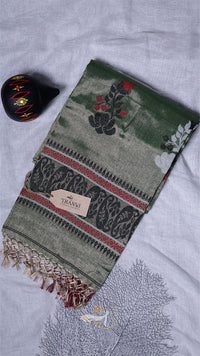 Green embroidered scarf with floral patterns on a light gray background