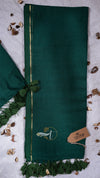 Green fabric with a logo and tag on a textured surface