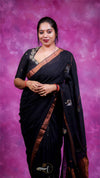 Woman in a black saree with a purple background