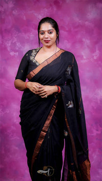 Woman in a black saree with a purple background