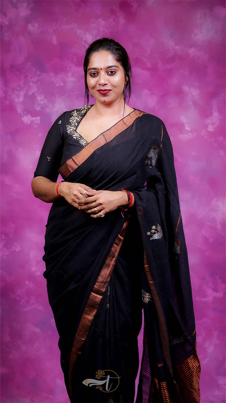 Woman in a black saree with a purple background
