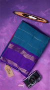 Purple and teal saree with a camera and loom on a purple background