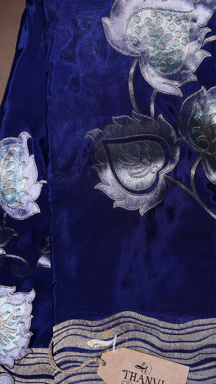 Navy blue fabric with intricate silver floral embroidery, brand tag visible.