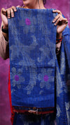 Person holding a blue floral patterned fabric against a purple background