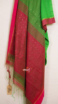 Red and green saree with a visible brand tag on a white background