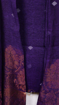 Close-up of a purple fabric with intricate patterns and textures.