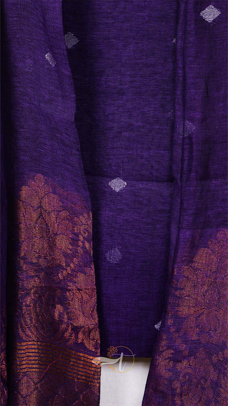 Close-up of a purple fabric with intricate patterns and textures.