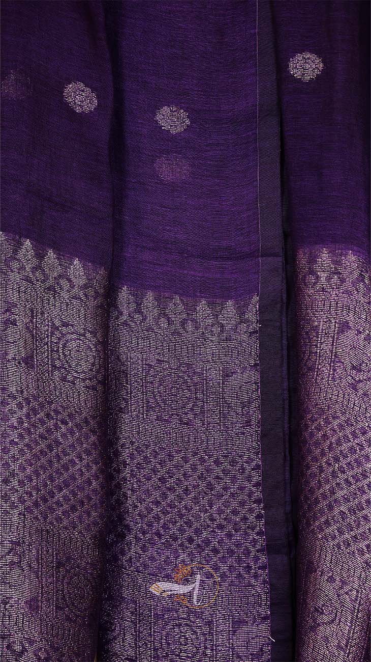 Close-up of a purple fabric with intricate patterns and designs.