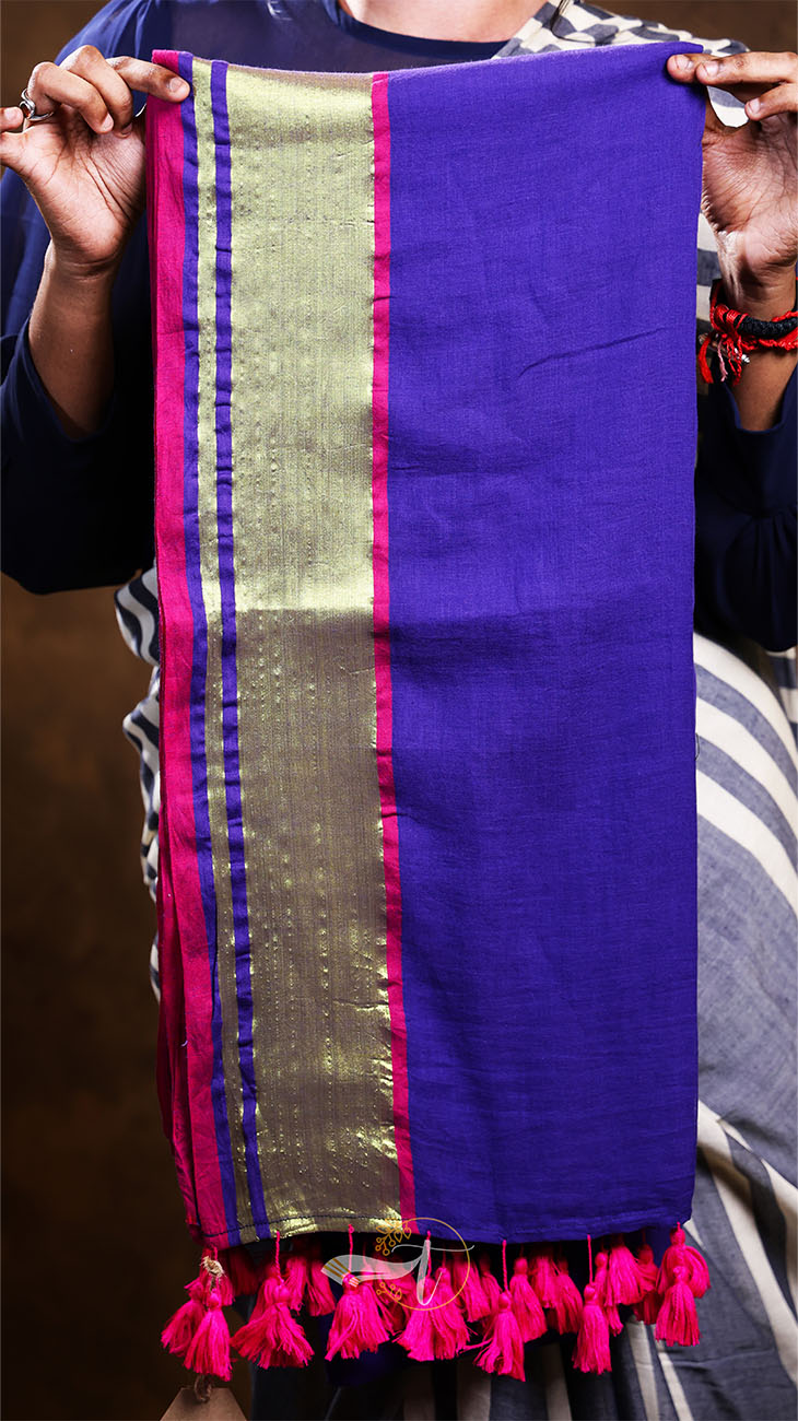 Purple fabric with gold and pink border held by a person