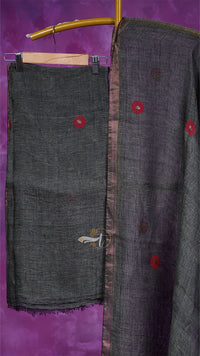 Dark gray fabric with red buttons on a purple background