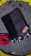 Dark gray tights with tassels on a textured surface with a brand tag.
