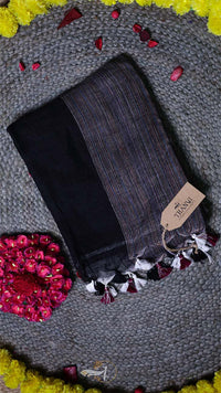 Dark gray tights with tassels on a textured surface with a brand tag.
