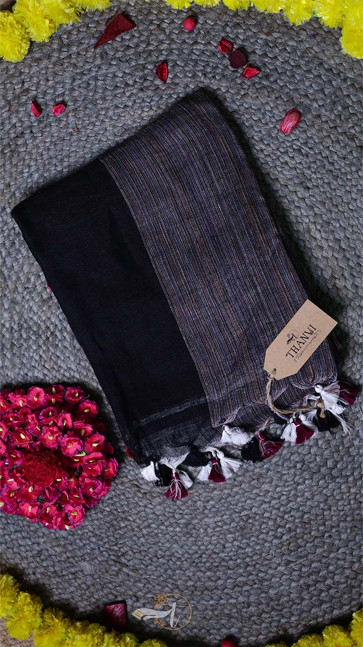 Dark gray tights with tassels on a textured surface with a brand tag.