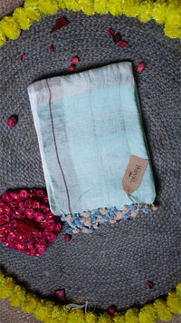 Light blue fabric with a brand tag on a textured surface with decorative elements