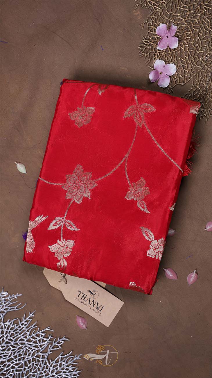 Red fabric with floral patterns on a brown background