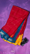 Red, blue, and yellow saree with a camera on a purple background