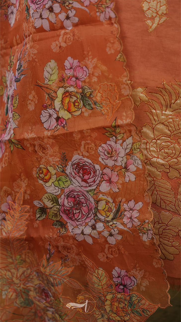 Close-up of orange fabric with floral embroidery
