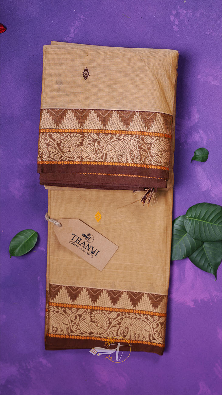 Beige saree with brown and orange patterns on a purple background