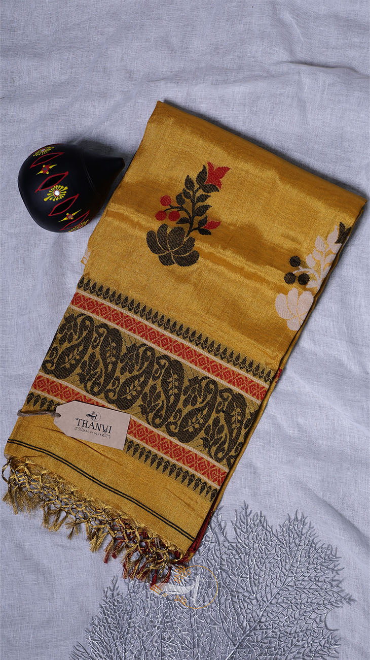 Yellow scarf with intricate patterns on a light gray background