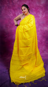 Woman wearing a bright yellow saree against a purple background