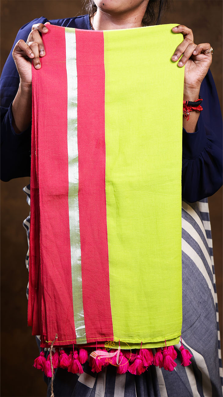 Person holding a colorful scarf with red and green stripes and pink tassels.