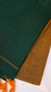 Close-up of green and brown fabric with orange tassels on a white background