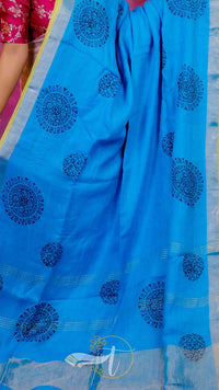 Blue saree with black patterns on a plain background