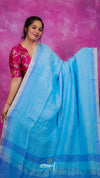 Woman wearing a blue saree with a pink background