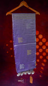 Purple saree with floral patterns on a hanger against a red background