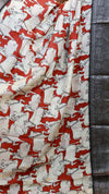 Fabric with a pattern of white animals on a red background, displayed against a dark fabric background.