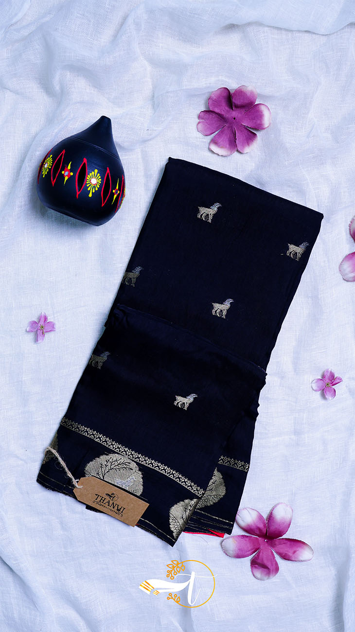 Black fabric with embroidered designs on a white background with flowers