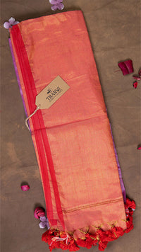 Folded saree with a visible brand tag on a brown background