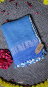 Blue towel with brand tag on a textured surface