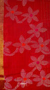 Red fabric with floral patterns on a brown background