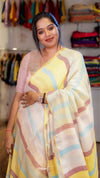 Woman wearing a yellow and pink saree with a colorful background