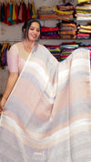 Woman holding a striped saree in a clothing store