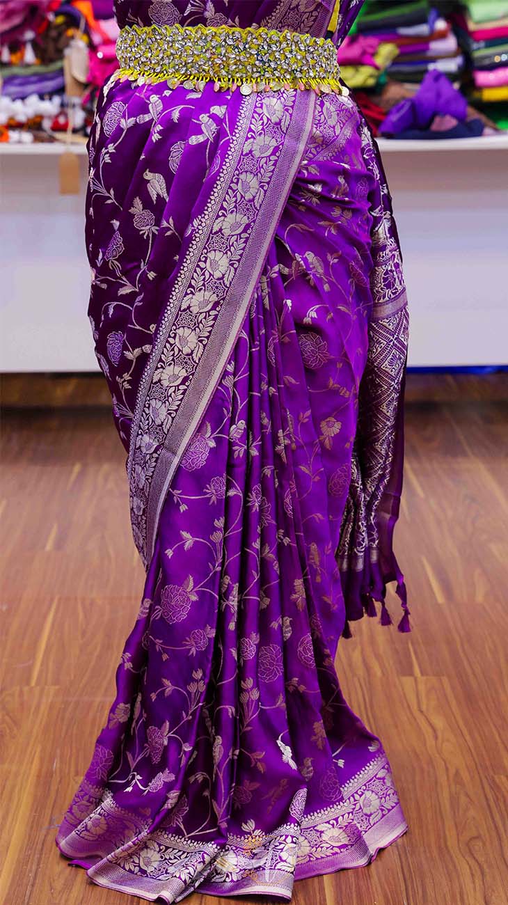 Purple saree with silver patterns on a wooden floor
