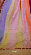 Colorful striped fabric with tassels on a purple background