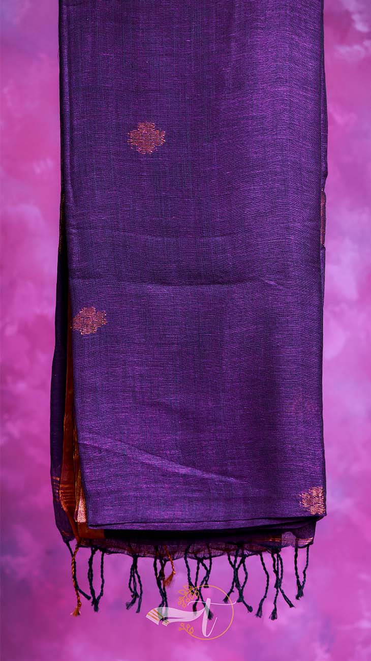 Purple fabric with gold patterns and tassels on a pink background