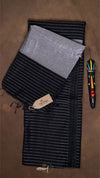 Black and gray striped fabric with a tag on a brown background