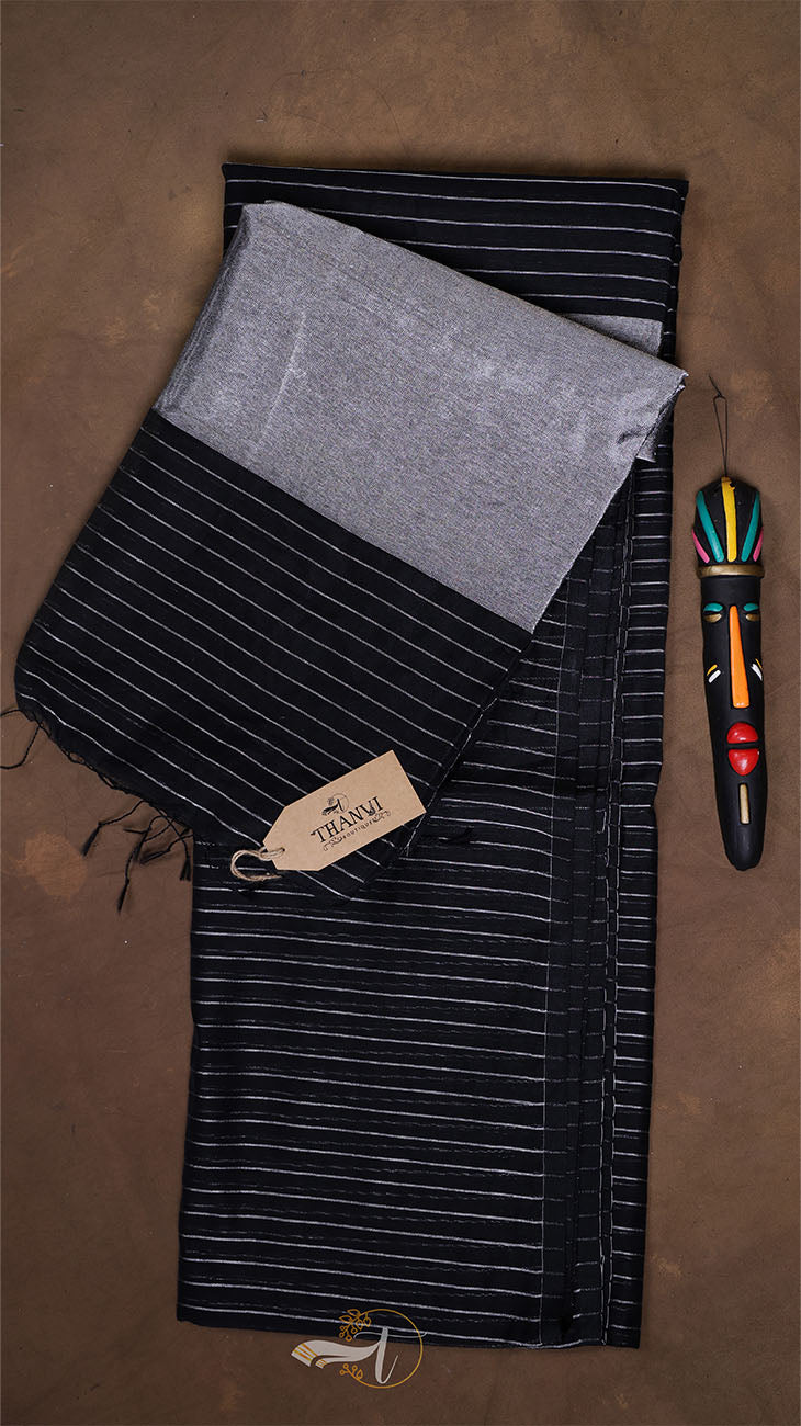 Black and gray striped fabric with a tag on a brown background
