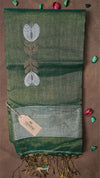 Green saree with floral patterns on a brown background