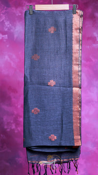 Dark blue saree with floral patterns on a pink background