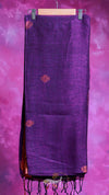 Purple scarf with red patterns and tassels on a pink background